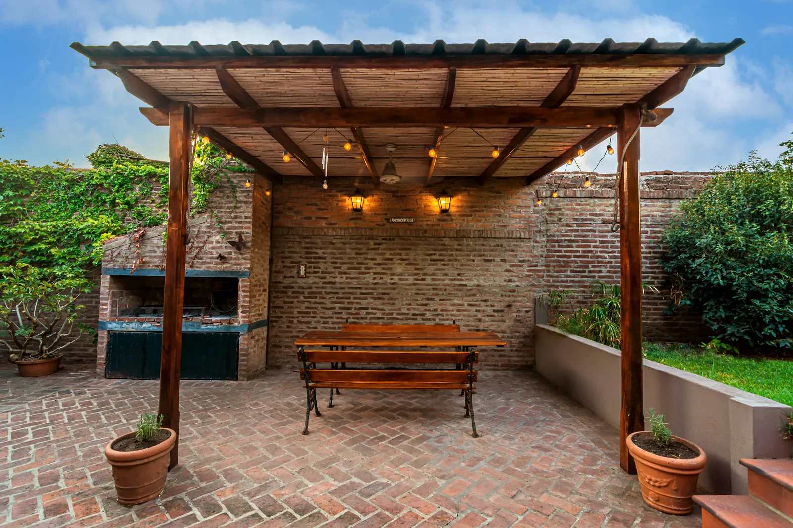 Contemporary paver patio with outdoor dining table and soft evening light